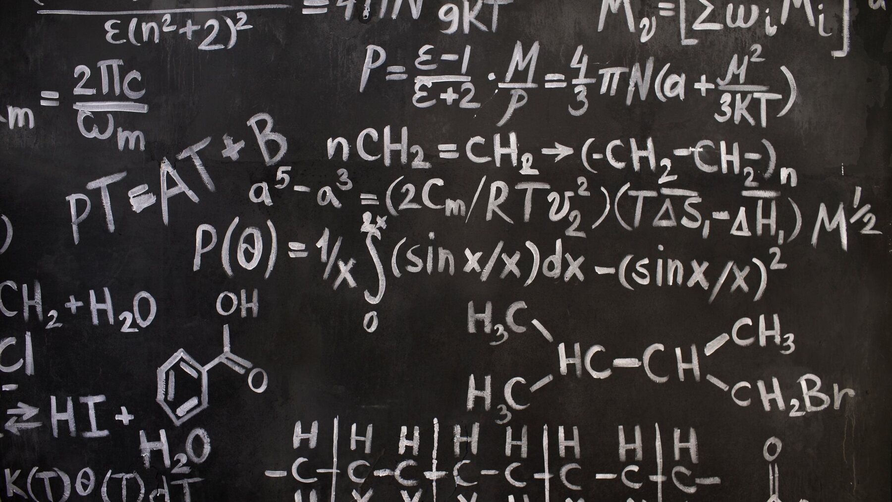 A blackboard covered in worked equations.